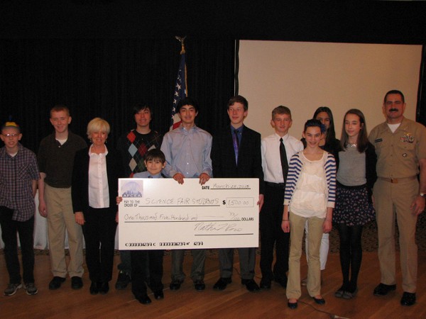 Omaha Metropolitan Science Fair award recipients at the March luncheon are (l-r) Simon Jones, King Science Center, 8th grade; Joe Thibodeau, St. Margaret Mary, 7th grade; Nancy Crews, chapter vice president of academics; Gus Seitzer, St. Margaret Mary, 7th grade; Justin DeLaRosa, Omaha North High School, 12th grade; Noah Moreano, Buffet Middle School, 8th grade; Ian Ritche, Buffet Middle School, 8th grade; Sean Orcutt, Buffet Middle School, 8th grade; Anna Sitzman, McMillan Magnet Center, 7th grade; Madeline Kane, McMillan Magnet Center, 7th grade; Averie Linnell, Buffet Middle School, 8th grade; and Cmdr. Anderson. The chapter awarded a total of $1,500 to the awardees.